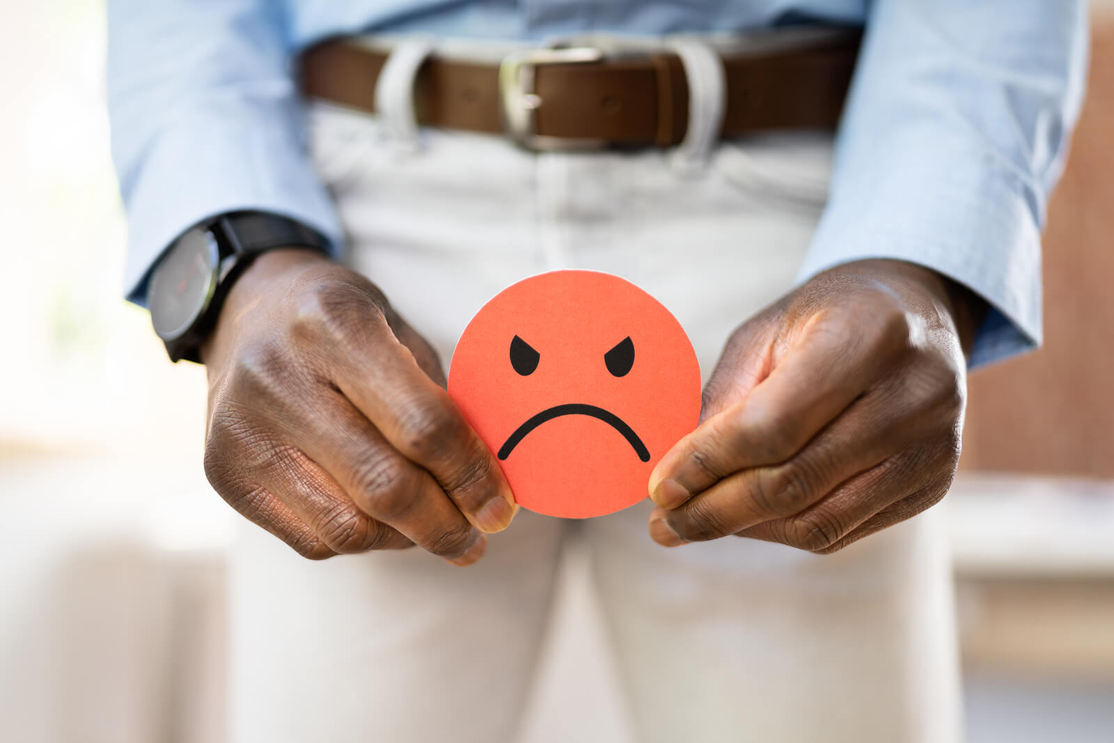 A man holds a unhappy face over his groin area representing his stress in dealing with male urinary incontinence. Pelvic Floor Physical Therapy for Male Urinary Incontinence in Washington, DC can help restore control.