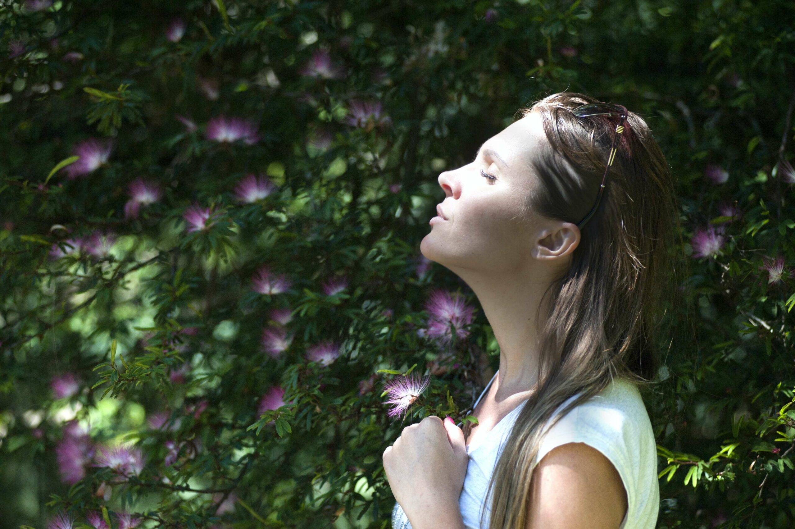 A woman practices breathing deeply to relax utilizing mindfulness exercises in Washington, DC.