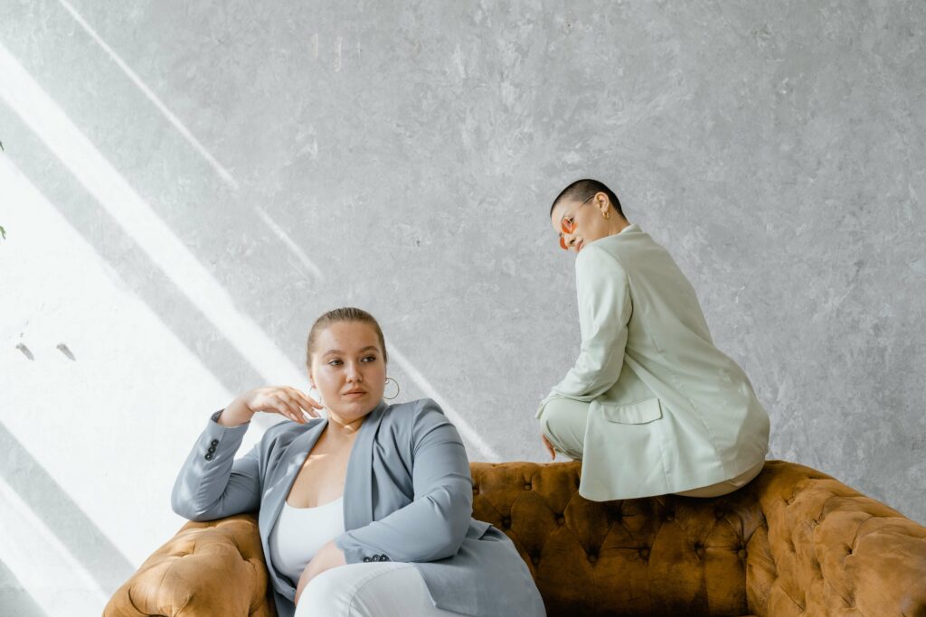 Two women sit on a couch waiting to work with a Pelvic Floor Physical Therapist in Washington, DC to address pelvic pain.