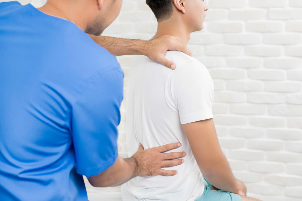 A therapist inspects the back of a person experiencing pelvic pain in Washington, DC. Learn how they can help teach pelvic floor exercises in Washington, DC by searching for lower back pain relief in Washington, DC today. 
