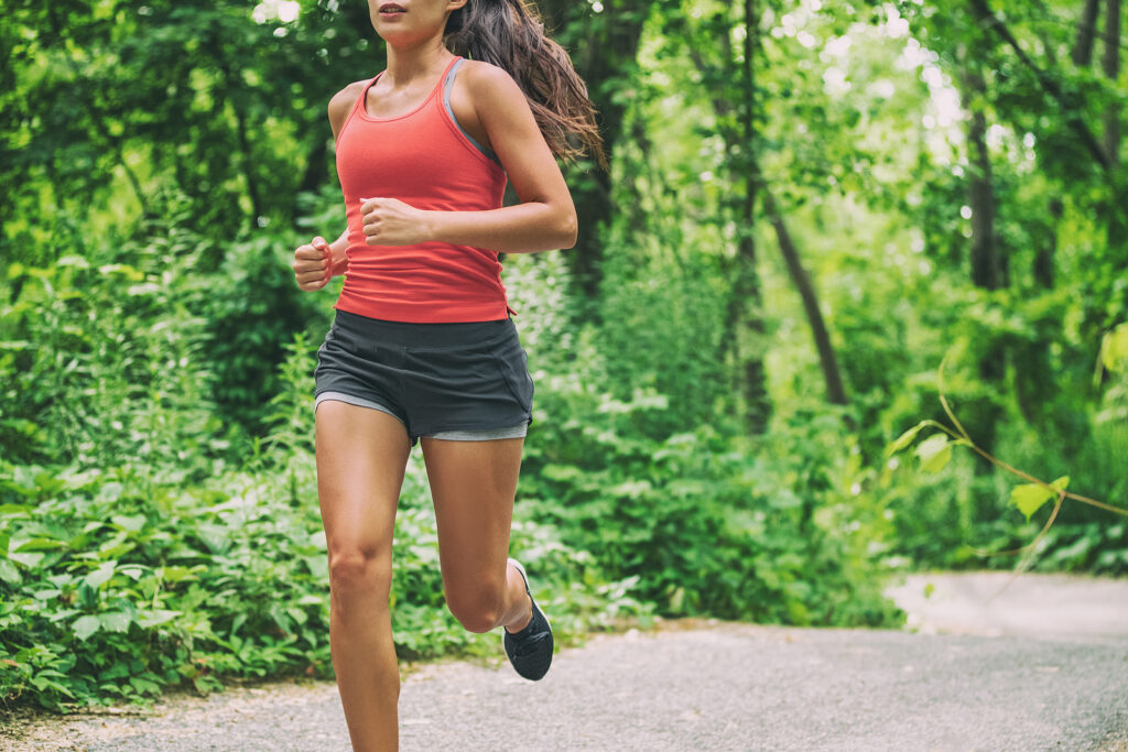A woman jogs alone through a forest path. This could represent getting back into a running routine after postpartum. Learn how postpartum pelvic floor physical therapy in Washington, DC can offer support in learning new tips. Search for pelvic pain in Washington, DC or pelvic health physical therapy in Washington, DC for support.
