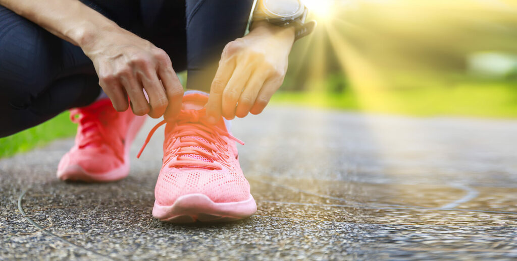 A close up of a person tying their shoes. Learn tips to jog after postpartum and how pelvic floor exercises in Washington, DC can help. Search for external pelvic floor manual therapy in washington, dc to learn more.
