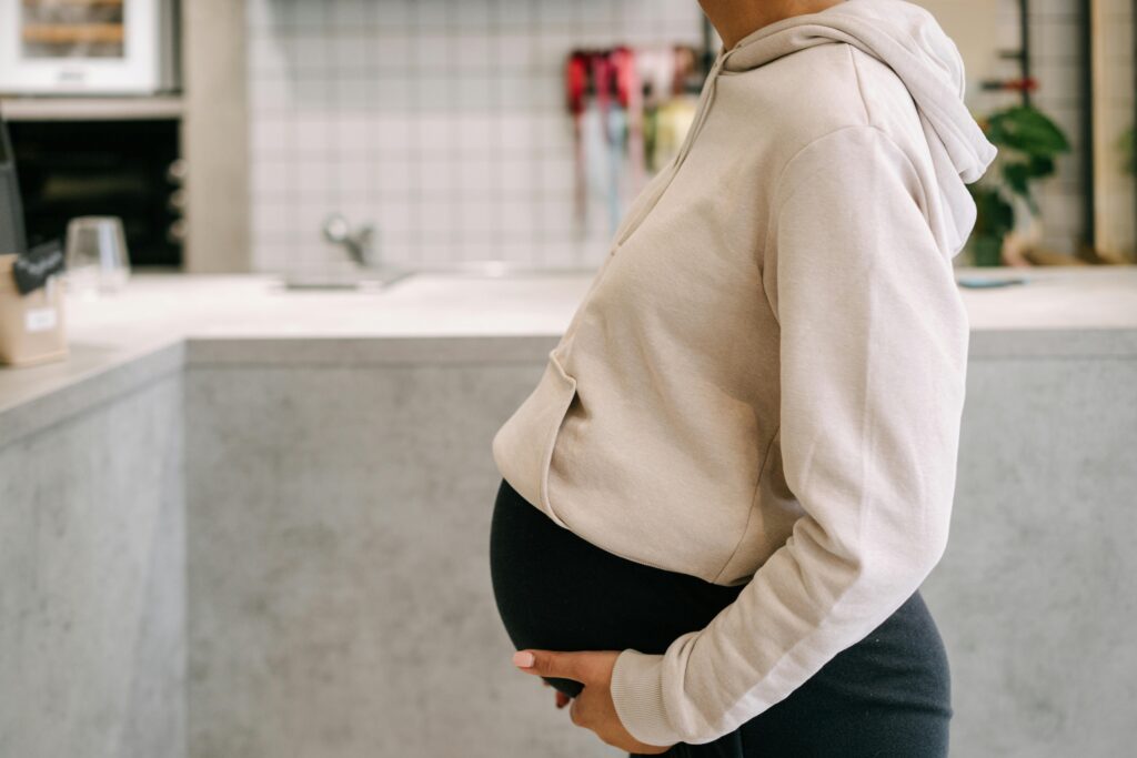 A Pregnant Woman Holding Her Baby Bump.